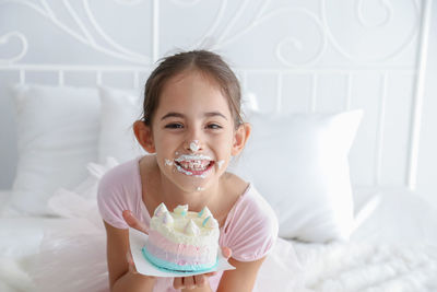 Portrait of smiling girl on bed