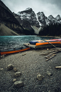 Colorful canoes on the shores of moraine lake on a cold autumn afternoon