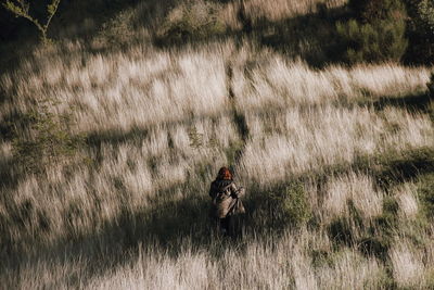 Rear view of woman on grassy field