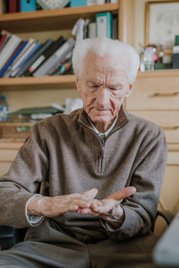 Man sitting on chair at home