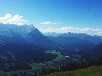 Scenic view of mountain range against cloudy sky