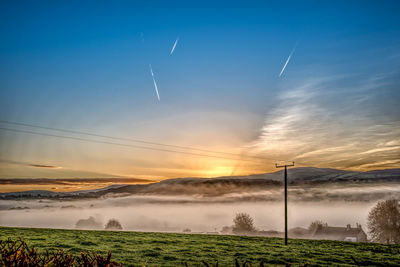 Scenic view of field against sky during sunset