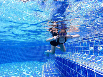 Portrait of girl swimming in pool