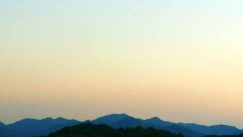 Scenic view of silhouette mountains against clear sky