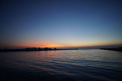 Scenic view of sea against clear sky at sunset