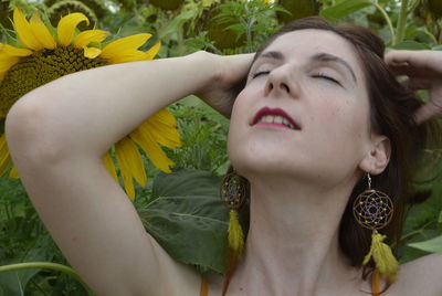 Portrait of woman lying down on plant