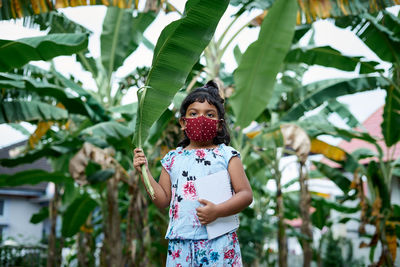 Low section of woman standing on plant