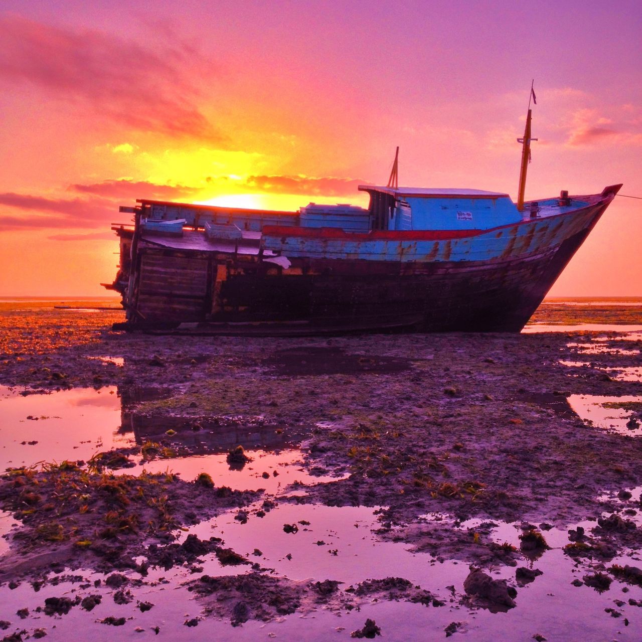 sunset, water, orange color, sky, sea, beach, built structure, sun, architecture, nautical vessel, shore, moored, scenics, boat, beauty in nature, transportation, nature, building exterior, tranquility, cloud - sky