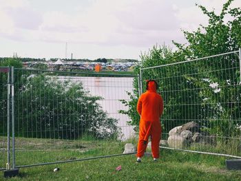 Rear view of man against trees and sky