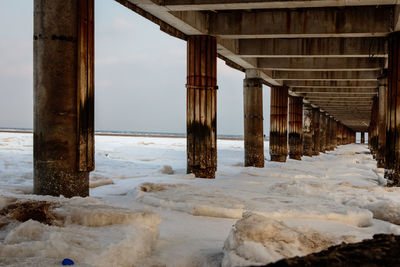 Scenic view of pier over sea during winter