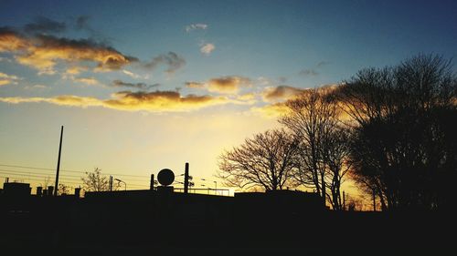 Low angle view of silhouette trees against sky at sunset