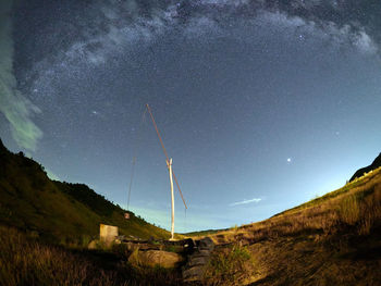 Low angle view of vapor trails in sky at night