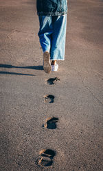 Low section of man standing on road