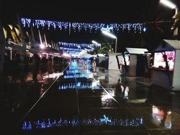 People in illuminated water at night