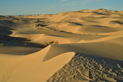 Sand dune in desert against sky