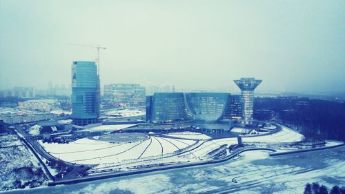 Snow covered buildings in city