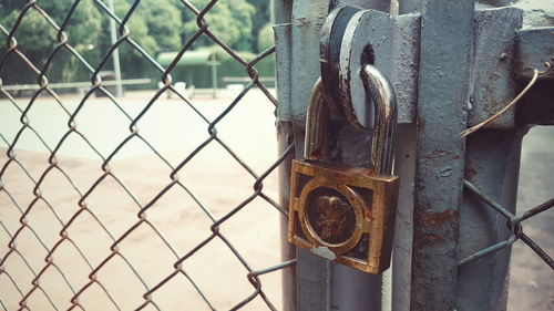 Close-up of padlock on metal gate