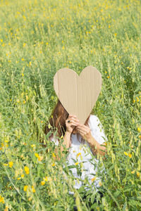 Woman with yellow flowers in field