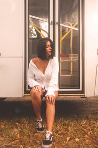 Full length of woman standing by window