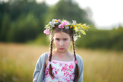 Portrait of cute girl with pink flower