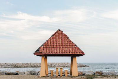 Lifeguard hut on beach against sky