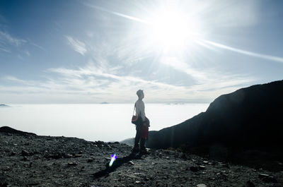 Man standing on mountain against sky