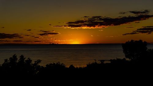 Scenic view of sea against orange sky