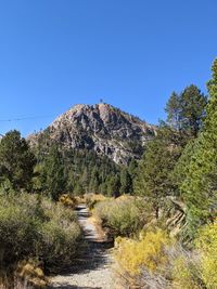 Scenic view of rocky mountains against clear blue sky