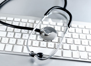 High angle view of stethoscope on computer keyboard