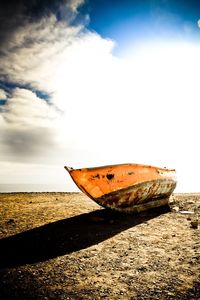 Airplane on beach against sky