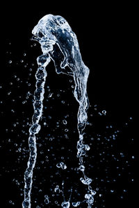 Close-up of water splashing against black background