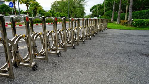Bicycles parked in row against sky