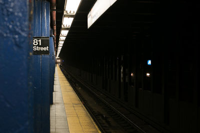 Information sign on column at illuminated subway station