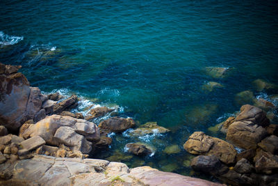 High angle view of rocks in sea