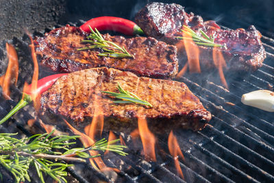 High angle view of meat on barbecue grill