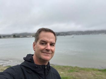 Portrait of man against lake