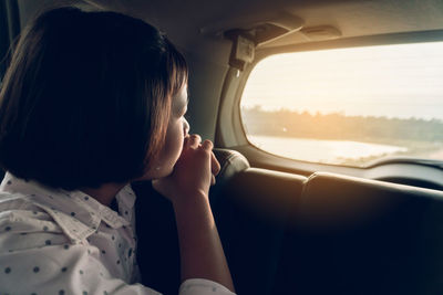 Portrait of woman sitting in car