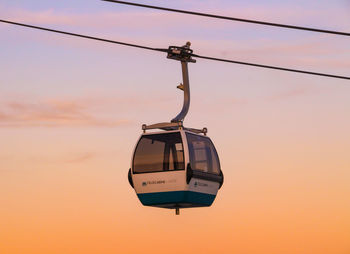 Overhead cable car against sky during sunset