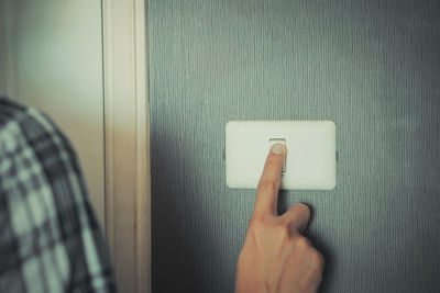 Close-up of human hand on door