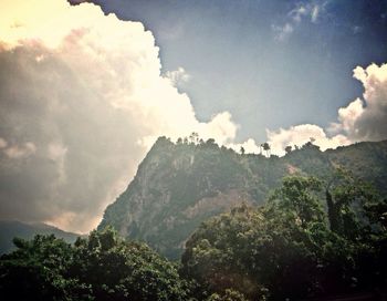Scenic view of mountains against cloudy sky
