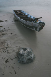 High angle view of abandoned boat moored on beach