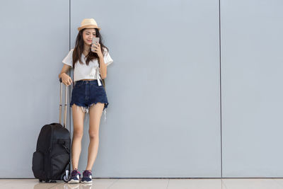 Full length of a young woman wearing hat