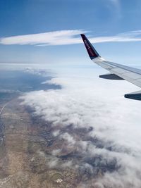 Aerial view of airplane flying in sky