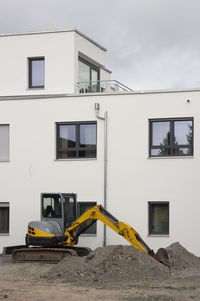 Exterior of yellow construction site against sky