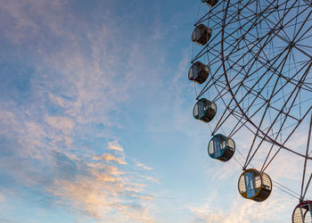 Low angle view of ferris wheel against sky