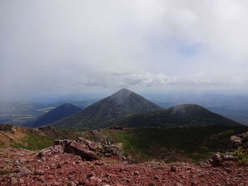 Scenic view of mountains against cloudy sky