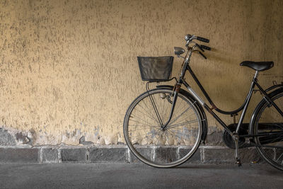 Bicycle parked against wall