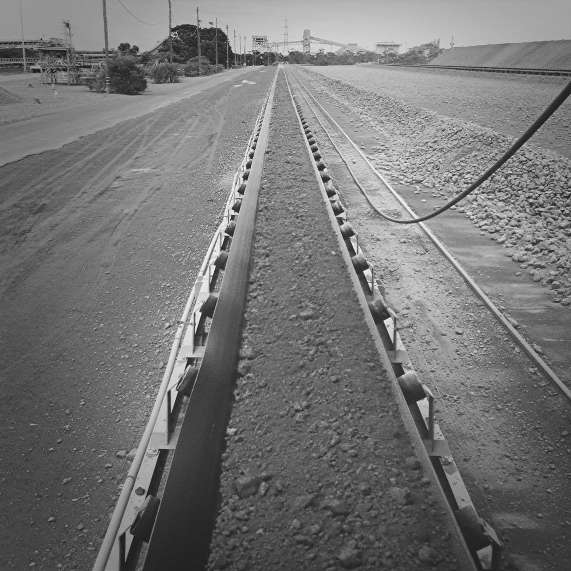 the way forward, transportation, diminishing perspective, vanishing point, railroad track, rail transportation, road, long, high angle view, straight, empty, road marking, day, outdoors, surface level, no people, sky, mode of transport, railway track, connection