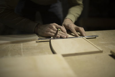 Midsection of man working on table