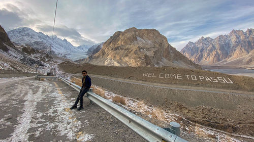 Man on snowcapped mountain against sky